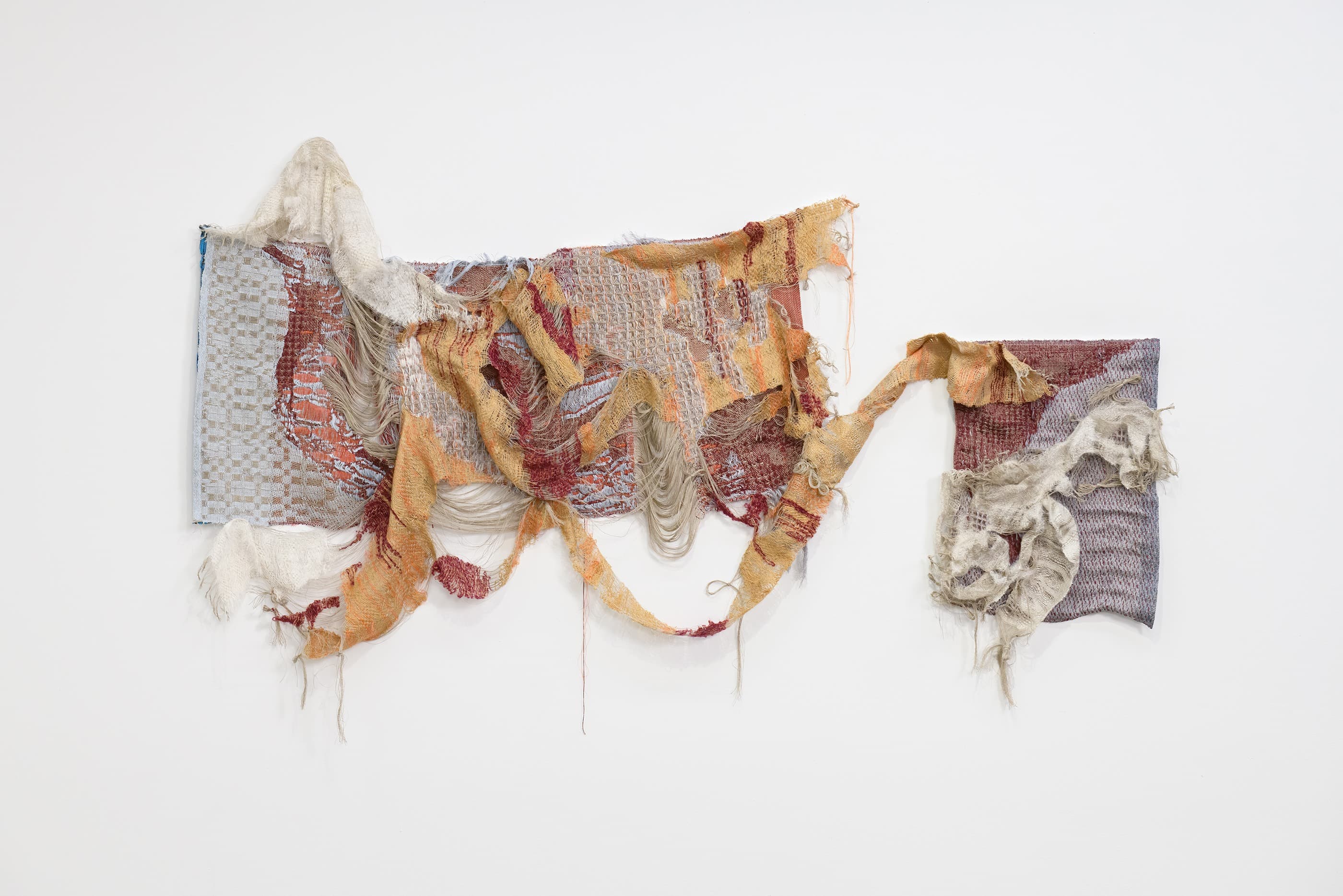 An abstract sculptural work with soft colors made of woven linen, wool, polyester, cotton, silk, and mohair that reflects the smoke moving across the United States from the 2020 California fires.