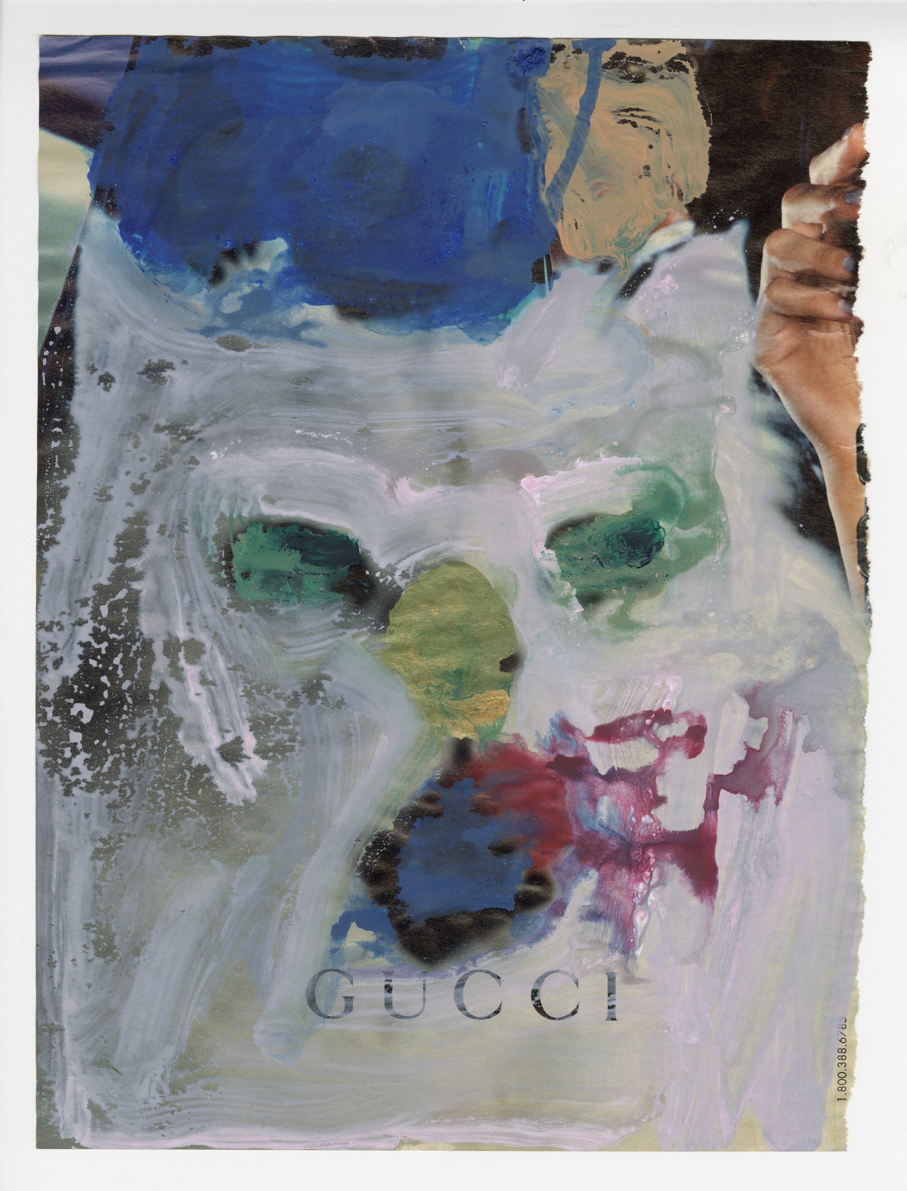 Abstract portrait painting with a fragmented face built from layered blue, gray, green, lavender, and burgundy brushstrokes. The face has dark green eyes, a blue upper section, and faint “GUCCI” lettering across the lower center, creating a textured, dreamlike effect.