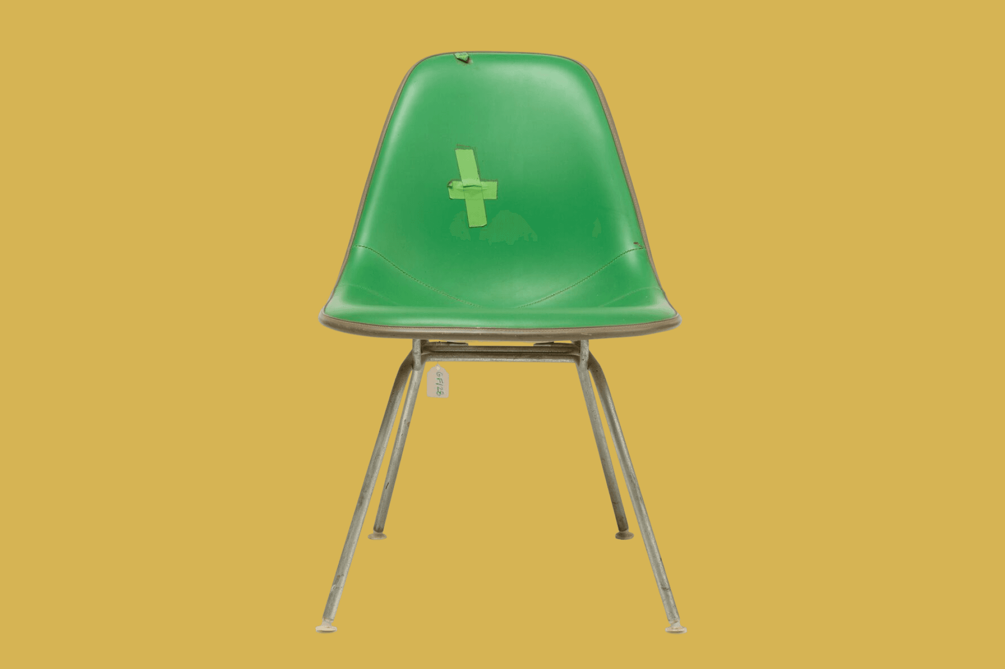 Vintage green MSX-1 Upholstered Side Chair designed by Ray and Charles Eames with small, cross-shaped patch on seat back.
