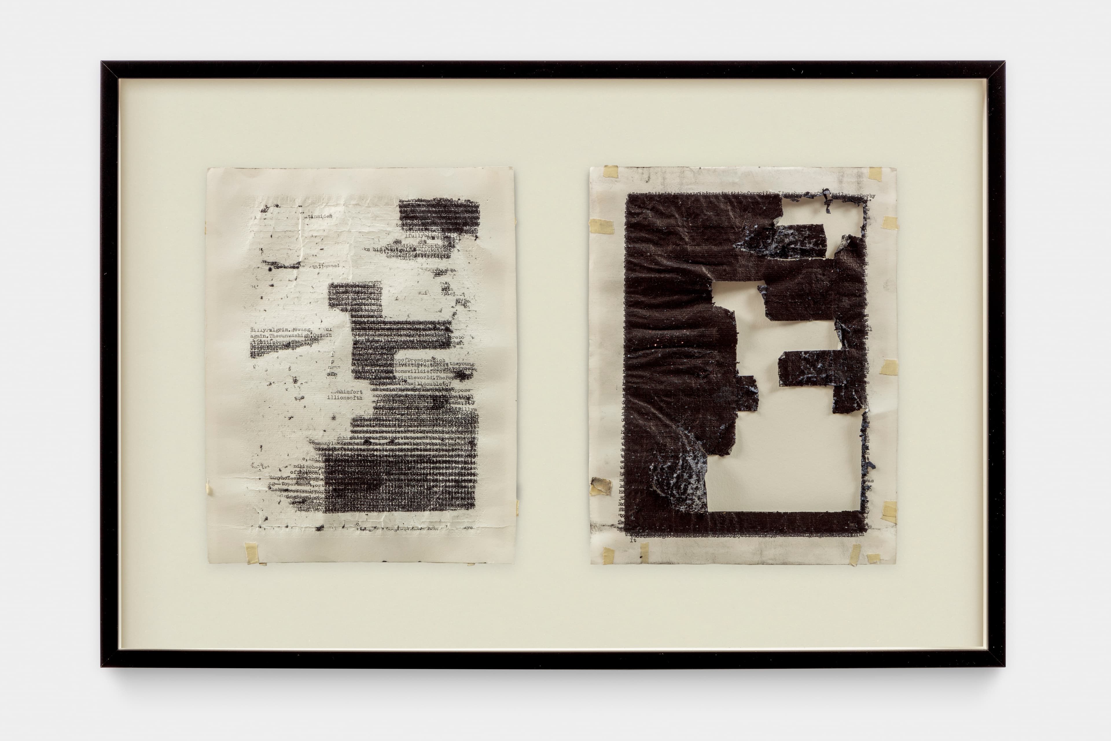 Two framed rectangular artworks are displayed side-by-side. The left piece is white, distressed fabric with dense, smudged black text. The right piece is dark, distressed fabric with large, irregular cut-outs revealing a light backing